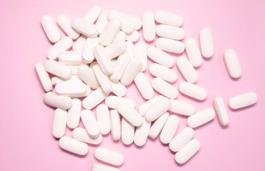 pharmaceutical medicine pills, tablets and capsules on pink background. Medicine concept.  
