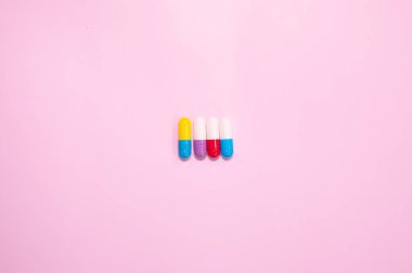 pharmaceutical medicine pills, tablets and capsules on pink background. Medicine concept.  