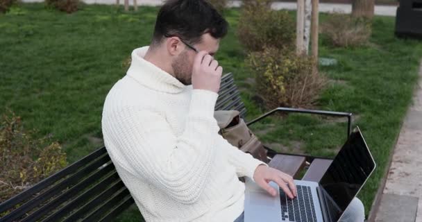 Młody Biały Mężczyzna Siedzi Ławce Pomocą Laptopa Cierpi Ból Głowy — Wideo stockowe