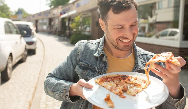 Snygg Ung Man Äter Bit Pizza Ute Gatan — Stockfoto