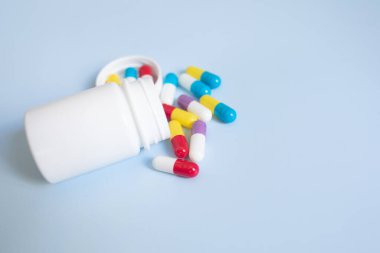 Işık arka planında beyaz kapsüllü hapların ve kapsüllerin yakın plan görüntüsü 