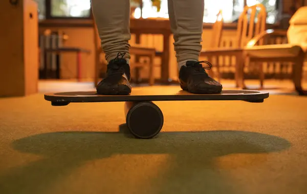 Balance board, close up view with athlete feet. Athlete training with balance board for sports