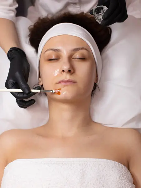 Cosmetology beauty procedure. Young woman skin care. Rejuvenation treatment. Facial chemical peel therapy.