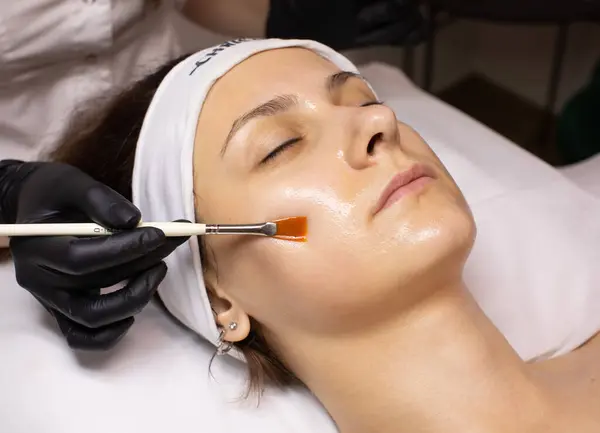 Cosmetology beauty procedure. Young woman skin care. Rejuvenation treatment. Facial chemical peel therapy.