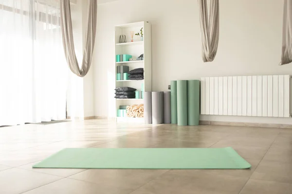 yoga room with green yoga mats