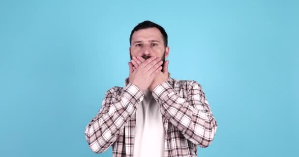 Utangaç Sakallı Adam Açık Mavi Arka Planda Ağzını Kapatıyor — Stok video