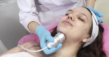 Klinikteki bir kozmetikçide yüz yenileme ameliyatı için gerekli radyoaktivite prosedürü. Estetik tıp kavramı. Yüzün ultrasonik temizliği      