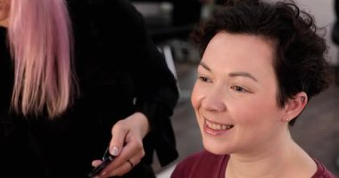 Profesyonel makyöz güzellik salonundaki güzel kadın mankene makyaj yapıyor..                      