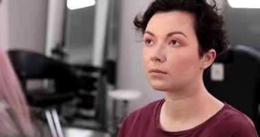 Profesyonel makyöz güzellik salonundaki güzel kadın mankene makyaj yapıyor..                      