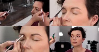 Profesyonel makyöz güzel genç bir kadınla çalışıyor. Genç manken için makyajı kapat. Makyaj sanatçısı makyaj yapıyor. Profesyonel makyöz, cazibe modeli makyajı yapıyor..         