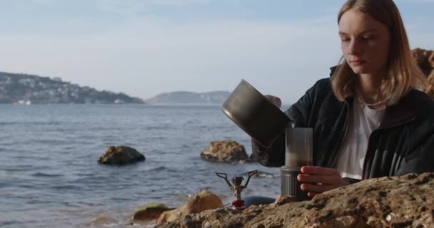 Жінка Робить Каву Конфорці Під Час Походу Морське Узбережжя Скелі — стокове відео