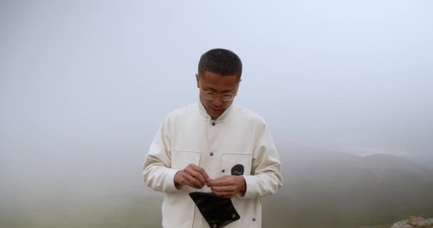 Stylish Young Hipster Man Glasses White Jacket Stands Background Fog — Stock Video