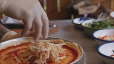 Mükemmel mutfak dünyasına dalın. Şefin eldivenleriyle süslenmiş yetenekli eller gibi. Titizlikle nefis bir pizza pişirin. Bu büyüleyici video pizza yapma sanatını gözler önüne seriyor.