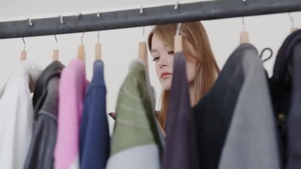 Obraz Představuje Mladou Ženu Kontemplativním Výrazem Která Probírá Výběrem Oděvů — Stock video