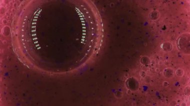 İçinde çok sayıda kabarcık ve parçacık bulunan kırmızı sıvı. Kabarcıklar boyut olarak değişir, çerçevede dinamik ve dokulu bir desen oluşturur. Kırmızı renk resme hakim olurken, küçük renk...