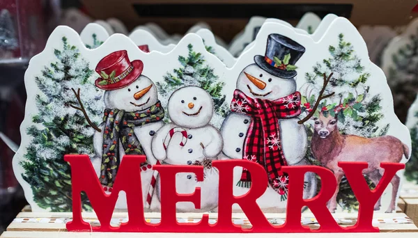 Merry Christmas - poster or postcard design with smiling Christmas snowmans. Christmas banner. Christmas holiday decorations. Nobody, selective focus