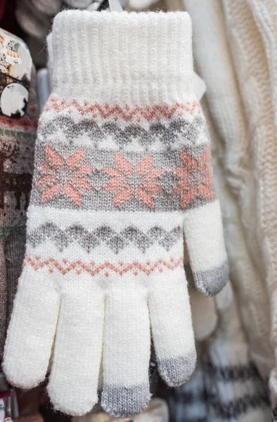Womens knitted wool winter gloves with pattern. Mittens knitted with jackard. Christmas and winter concept. Nobody, selective focus
