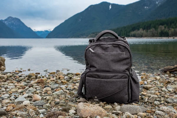 stock image Backpack on the mountain and lake background. Scenic nature on mountain in Canada with backpack. Nobody, travel photo, selective focus