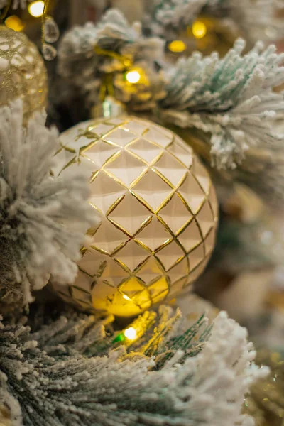 Gold ball decoration on christmas tree. Christmas baubles on christmas tree. Nobody, selective focus, Christmas and New Year concept.