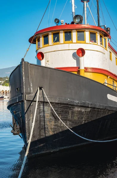 Old tugboat in a sunny summer day. Tug boats are working in a harbor. Offshore supply boat in a calm weather day. Nobody, selective focus, travel photo