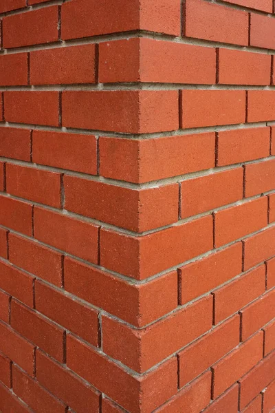 Red brick texture of the corner of the house. New Brick wall for background. House corner, Brick work, brick edge, nobody