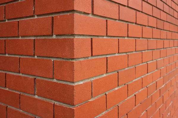Red brick texture of the corner of the house. New Brick wall for background. House corner, Brick work, brick edge, nobody