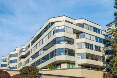 Modern apartment buildings on a sunny day with a blue sky. Facade of a modern apartment building. Multistoried new stylish living block of flats minimalistic architecture-Surrey Canada-January 10,2023