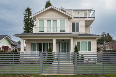 Beautiful Home Exterior. Real Estate Exterior Front House. Luxury house with beautiful landscaping with fence. House with nicely trimmed and landscaped front yard in a residential neighborhood