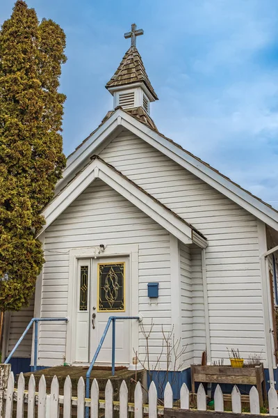 Small white wooden church in the country. A little white country church in rural Canada. Nobody, street photo, copy space for text