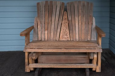 Adirondack chairs sits on a cottage wooden deck. Muskoka chairs at the garden. Garden wooden chairs. Nobody, selective focus