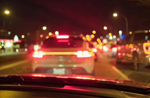 Night road in the city of lights cars traffic jams. Blurred Defocused Lights of Heavy Traffic. Evening traffic. The city lights. Motion blur. Nobody