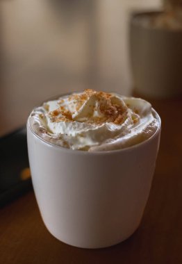 Masanın üzerinde sütlü kahve bardağı var. Kahvaltıda sabah kahvesi. Hiç kimse, bulanık, seçici odaklanma