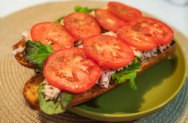 Homemade Tuna Sandwich with Tomatoes and Lettuce. Tuna sandwich on a plate. Nobody, close up