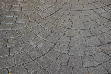 Stamped concrete pavement cobblestones pattern, decorative appearance textures of paving cobblestones tile on cement flooring in a park. Printed grey concrete path. Nobody