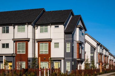 New residential townhouses. Modern apartment buildings in Surrey BC Canada. Modern complex of apartment buildings. Concept of real estate development, house for sale and housing market