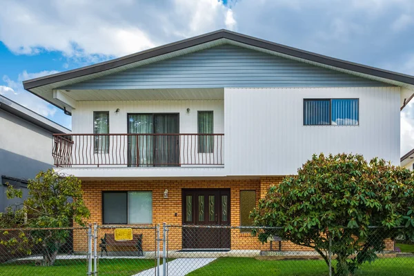 stock image Real Estate Exterior Front House on a sunny day. Big custom made luxury house with nicely landscaped front yard and fence in the suburbs of Vancouver Canada