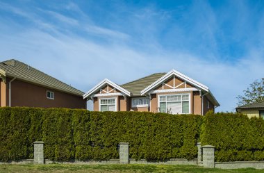 Houses in suburb in the north America. Top of a luxury house with nice windows over blue sky. Beautiful Home Exterior. Real Estate Exterior Front House.nobody, selective focus