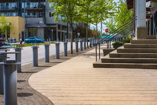 stock image Empty alley walkway nearby office buildings. Modern City street in downtown. Entrance with stairs and trees at summer time. Urban big city life concept background. Street photo, nobody
