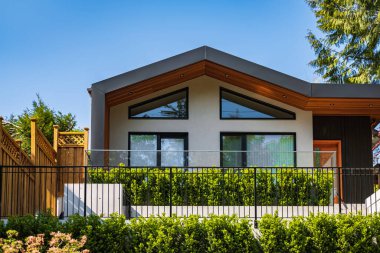 Houses in suburb in the north America. Top of a luxury house with nice windows over blue sky. Beautiful Home Exterior. Real Estate Exterior Front House.nobody, selective focus