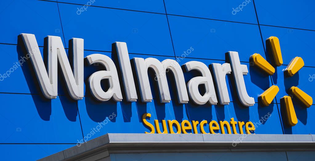Walmart superstore exterior facade brand and logo signage on blue background. Walmart is an American multinational retail corporation that operates a chain of hypermarkets-July 20,2023-Surrey Canada