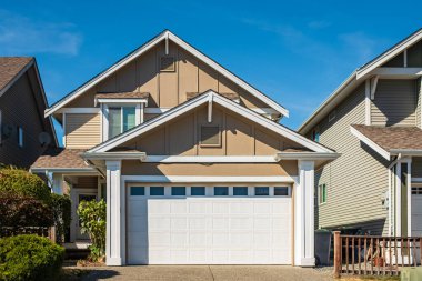 Vancouver Canada 'nın dışındaki modern ev. Güzel bir peyzaj ve garaj yolu olan büyük, modern bir ev. Modern tasarlanmış konut evinin ön görüntüsü. Banliyödeki Kuzey Amerika Evi