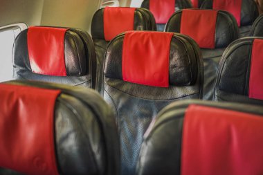 Empty passenger airplane seats in the cabin. Seat rows in an airplane. Interior of the passenger airplane. Seats in the cabin economy class. Nobody, travel concept. clipart