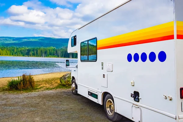Family vacation travel RV, holiday trip in motorhome. Caravan car Vacation. Beautiful Nature Canada landscape. Caravan in a relaxing nature camp site by the forest lake. Camping vacation family travel