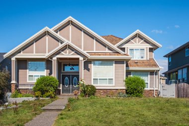 Real Estate Exterior Front House on a sunny day. Big custom made luxury house with nicely landscaped front yard and driveway to garage in suburbs. Modern designed home, New construction home exterior clipart