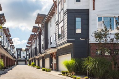 Vancouver BC 'deki yeni modern apartman binaları. Güneşli bir günde Kanada modern konut mimarisi. Kanada modern konut mimarisi, düşük katlı yeni konutlar. Komşu modern evler