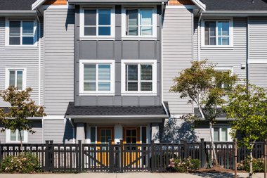 New residential townhouses. Modern apartment buildings in Surrey BC Canada. Modern complex of apartment buildings. Concept of real estate development, house for sale and housing market
