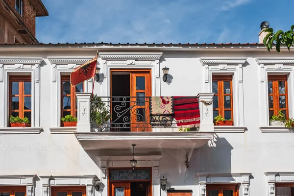 Albanian flag on the traditional house in Albania, Historical Houses in old city in a beautiful summer day, street photo. Albania traveling concept background