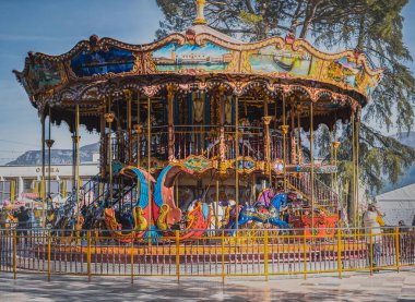 Carousel with colorful horses at amusement park, Merry go round with horse, Vintage ride attraction for children clipart