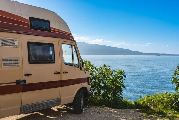 Motor homes, camper vans at sunset beach. Travel adventure vacation concept background. Caravan car by the sea in summer holidays. Travelers with camper van are resting on an active family vacation