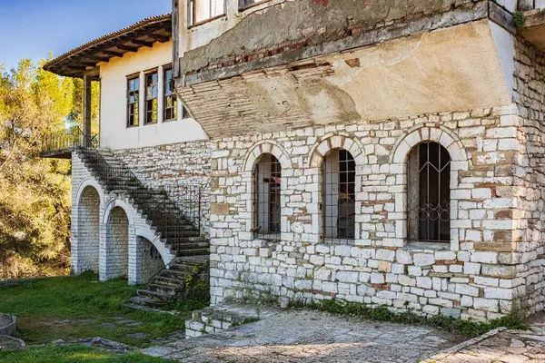 Abandoned house with architecture typical of Mediterranean countries. Old abandoned historical stone house in rural Albanian countryside. Traditional Mediterranean architecture